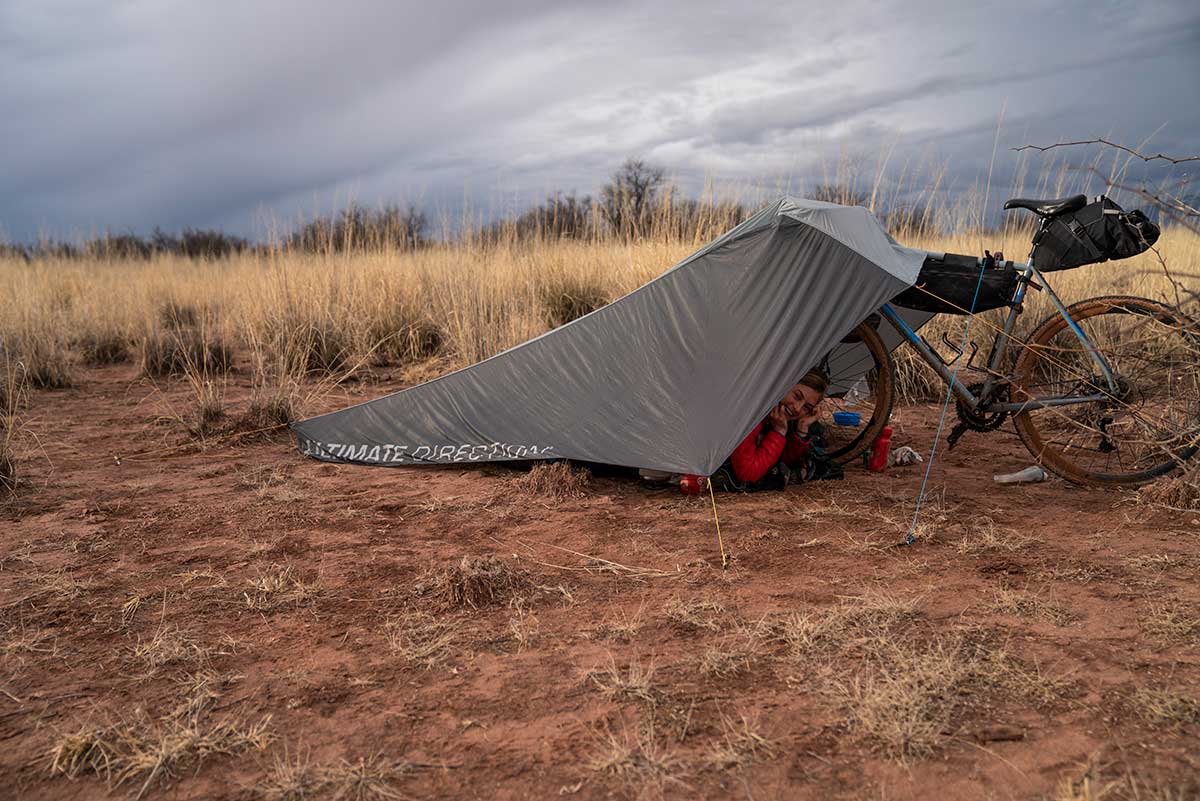 Ultimate Direction Bike Tarp Conversion Kit creates a bicycle-supported shelter