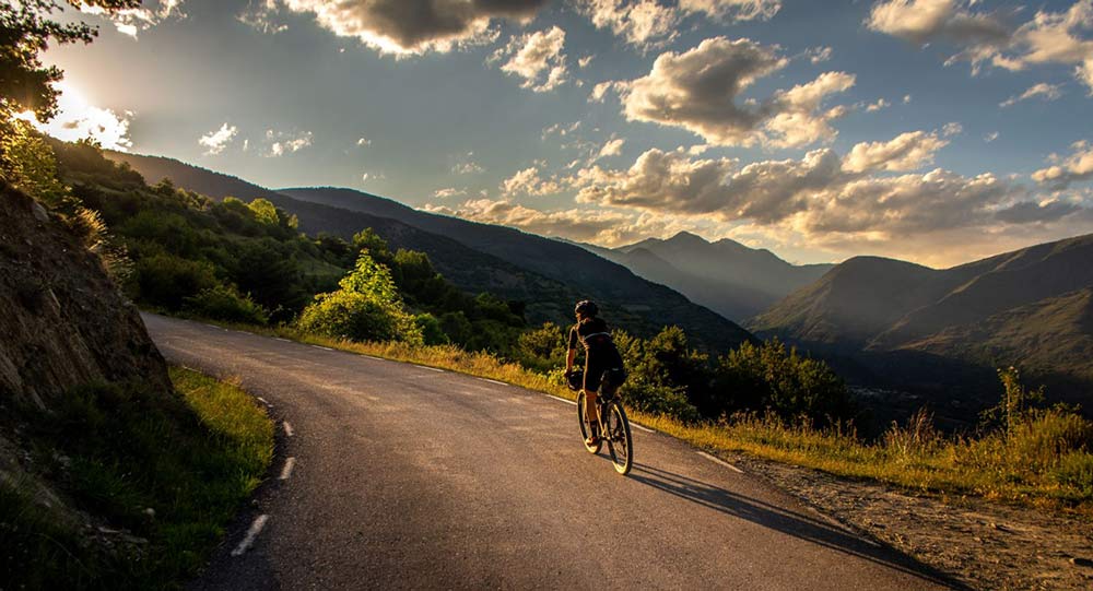 riding gravel bikes through girder forest in the pyrenees in Spain