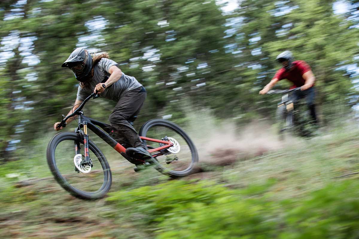 mountain biker rides fast straight line rough section specialized stumpjumper evo trail bike 29er