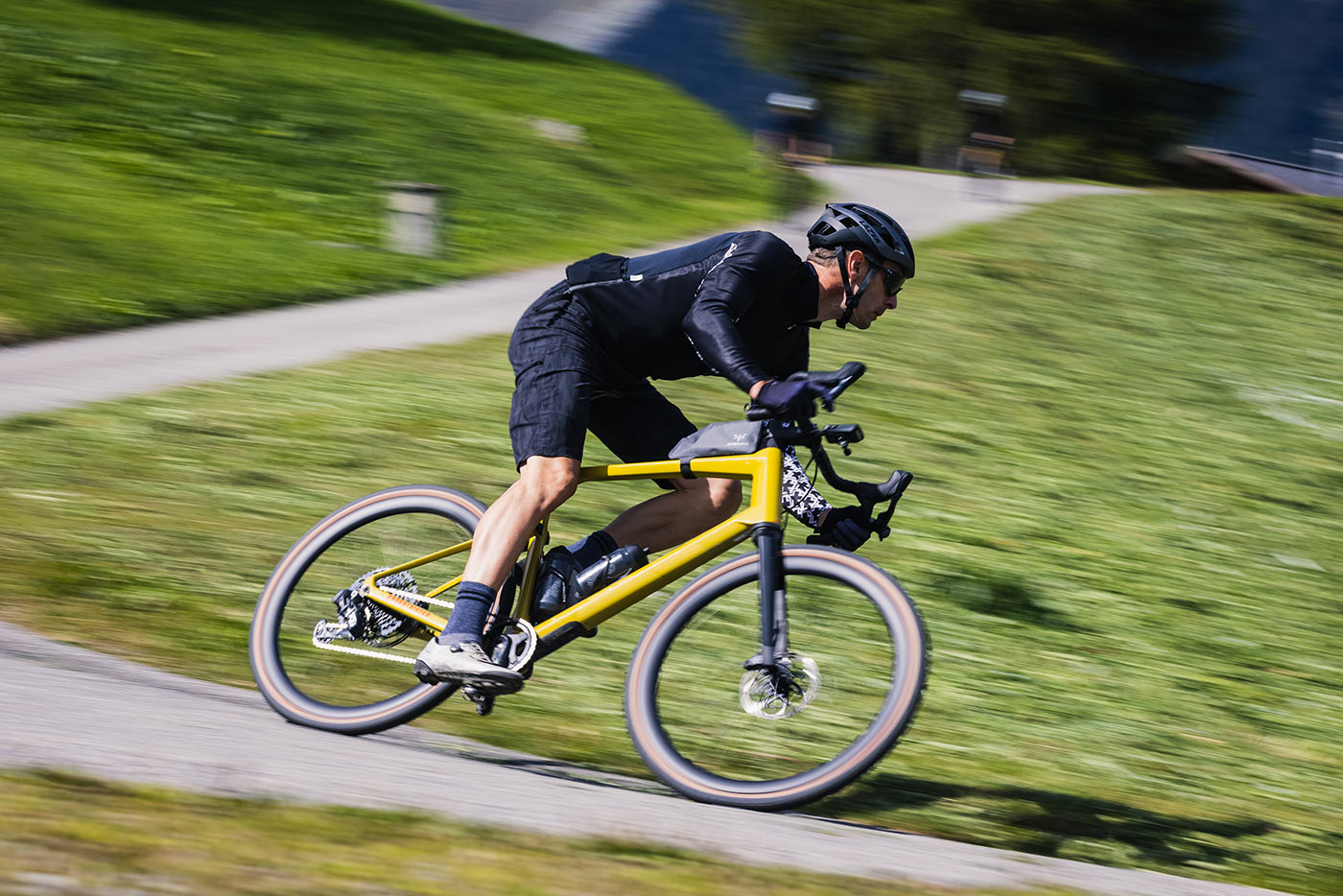 high speed cornering on the bmc urs lt full suspension gravel bike on the road