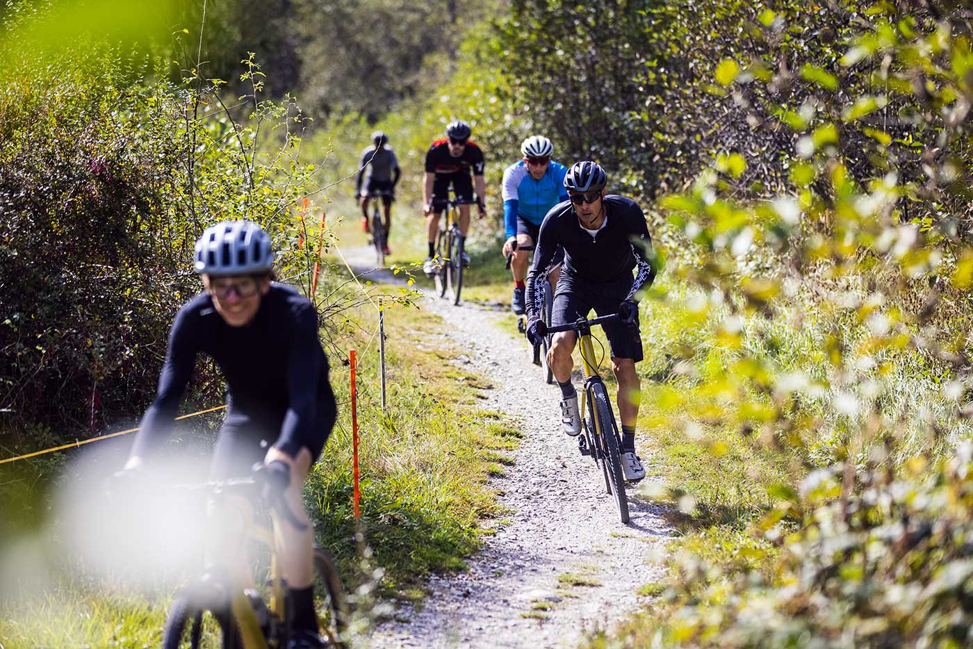 riding the bmc urs lt full suspension gravel bike on a trail