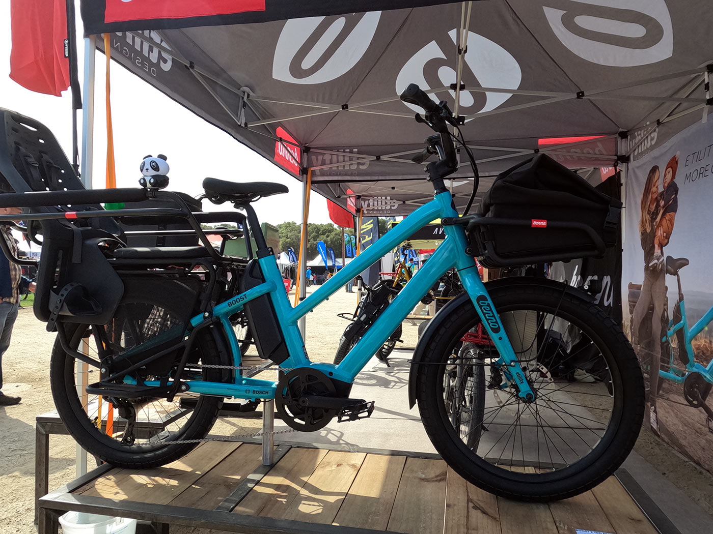 benno boost step-thru e-cargo bike with child seat on rear rack