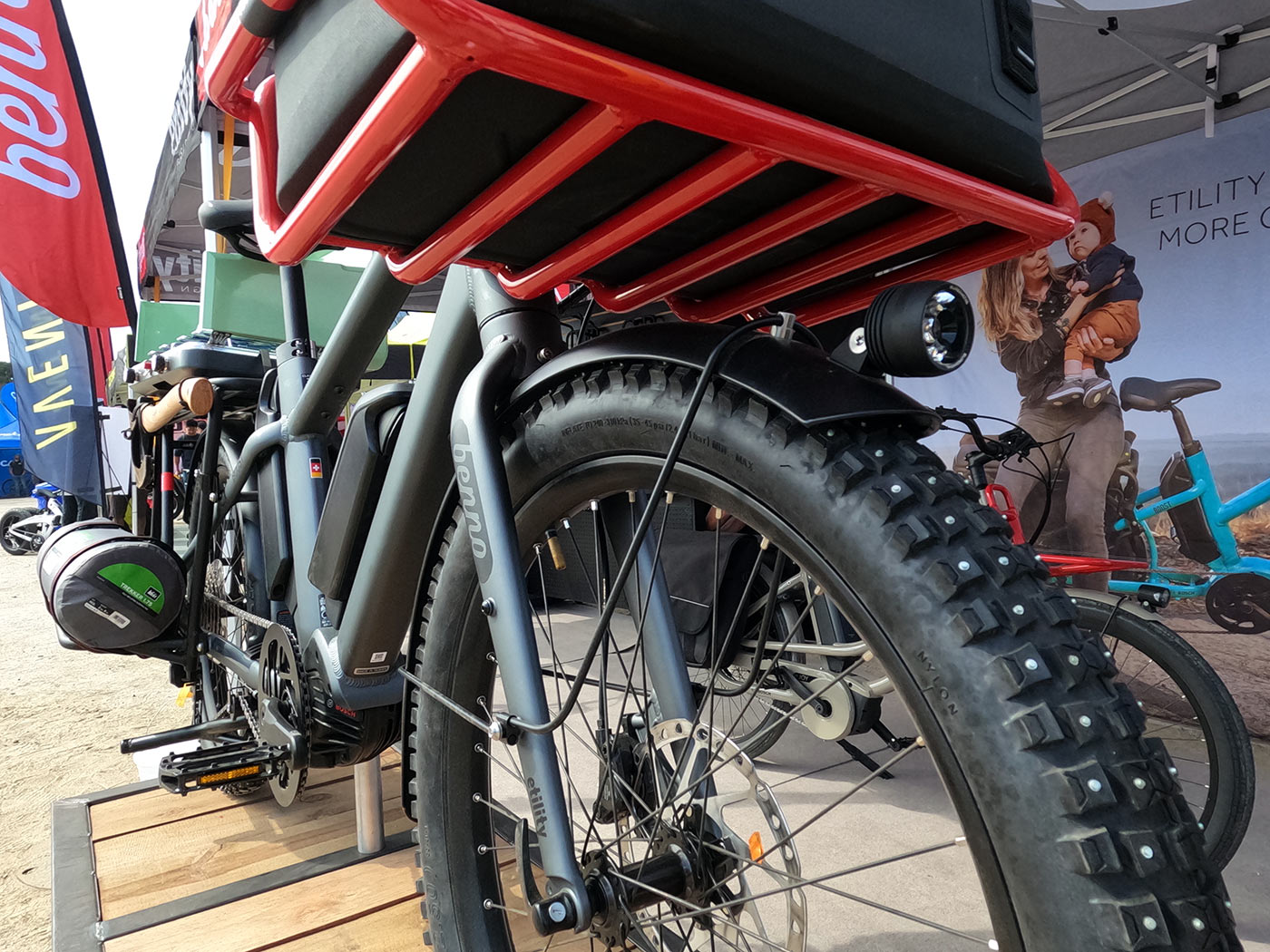 benno boost e-cargo bike with studded mountain bike tires and overlanding setup with stove and axe