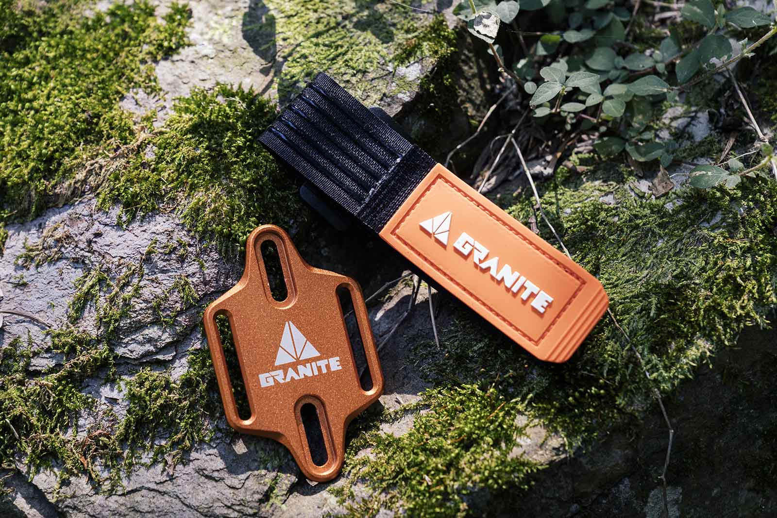 the granite design portaledge sitting on a mossy rock