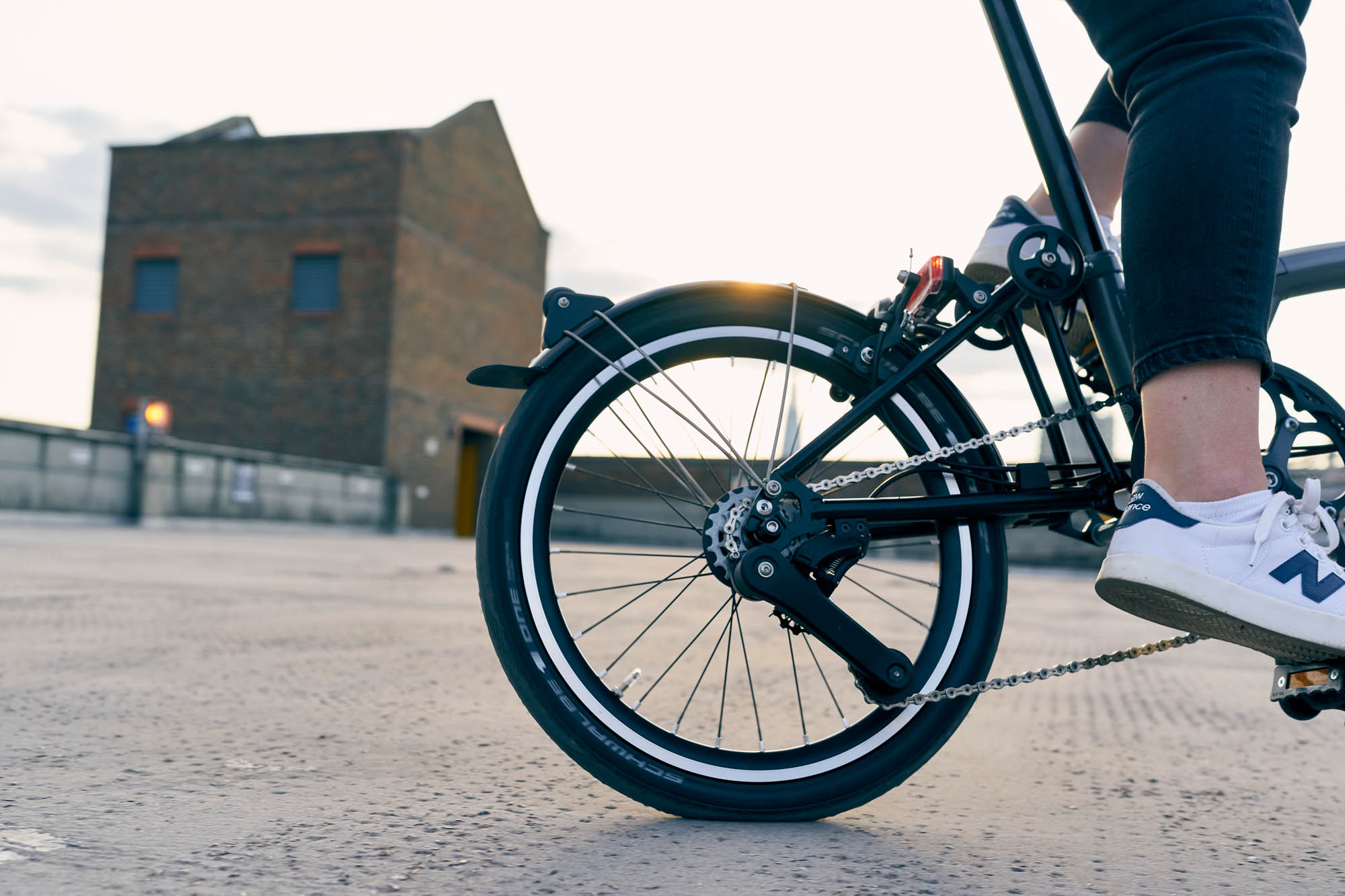 Photo of rear wheel and groupset of the Brompton P line bike while being ridden. Side view.