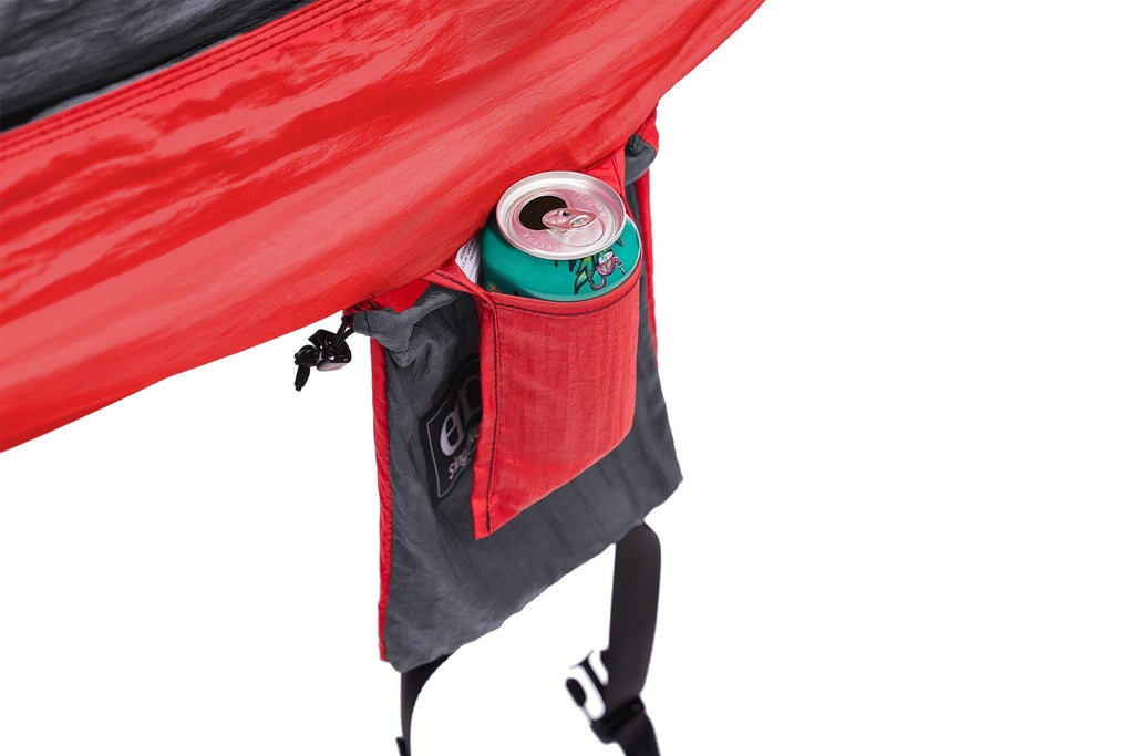 A couple mounts and ENO hammock to trees in a forest.