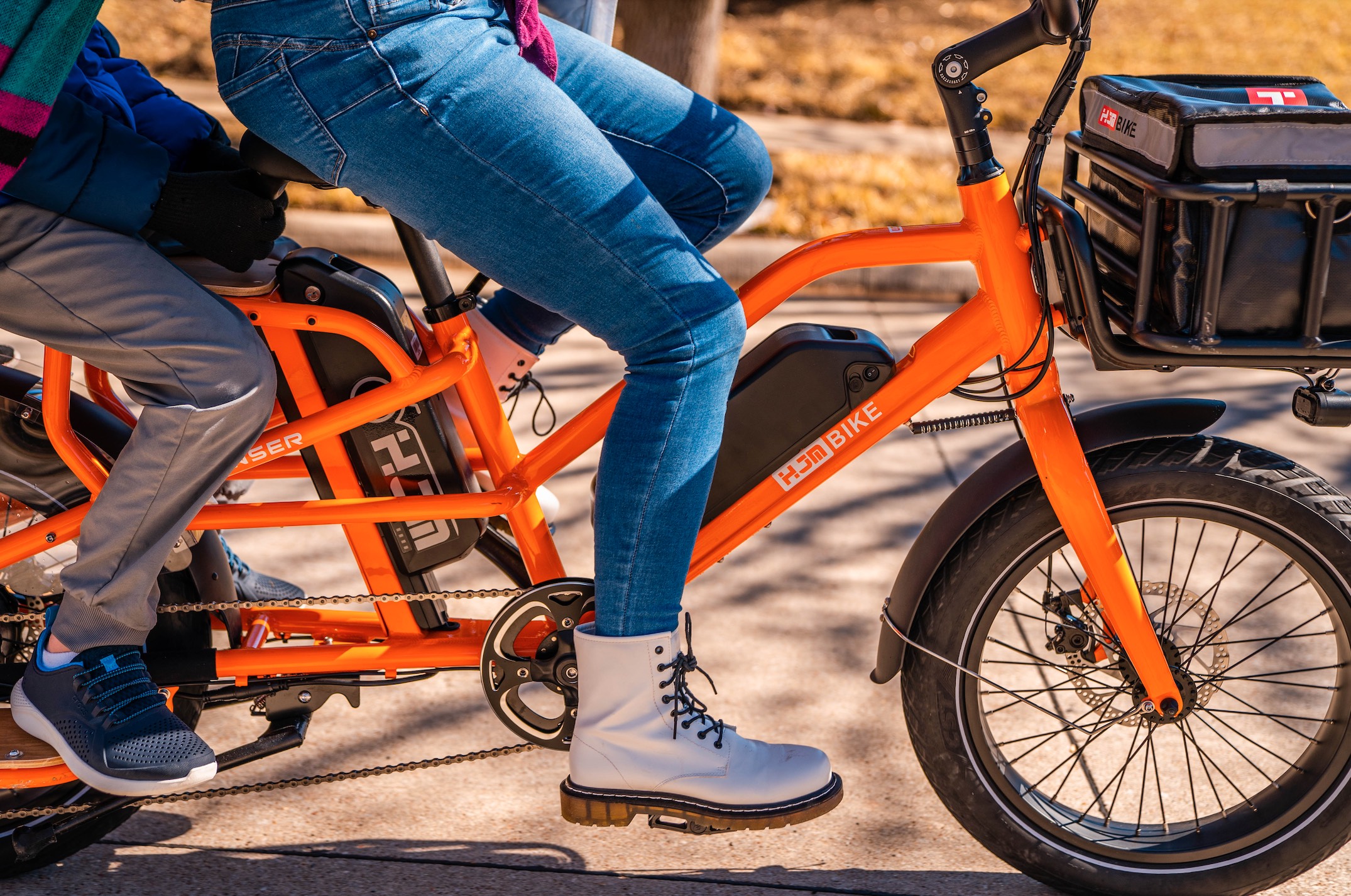 HJM Transer Cargo e-bike with rider and passenger.
