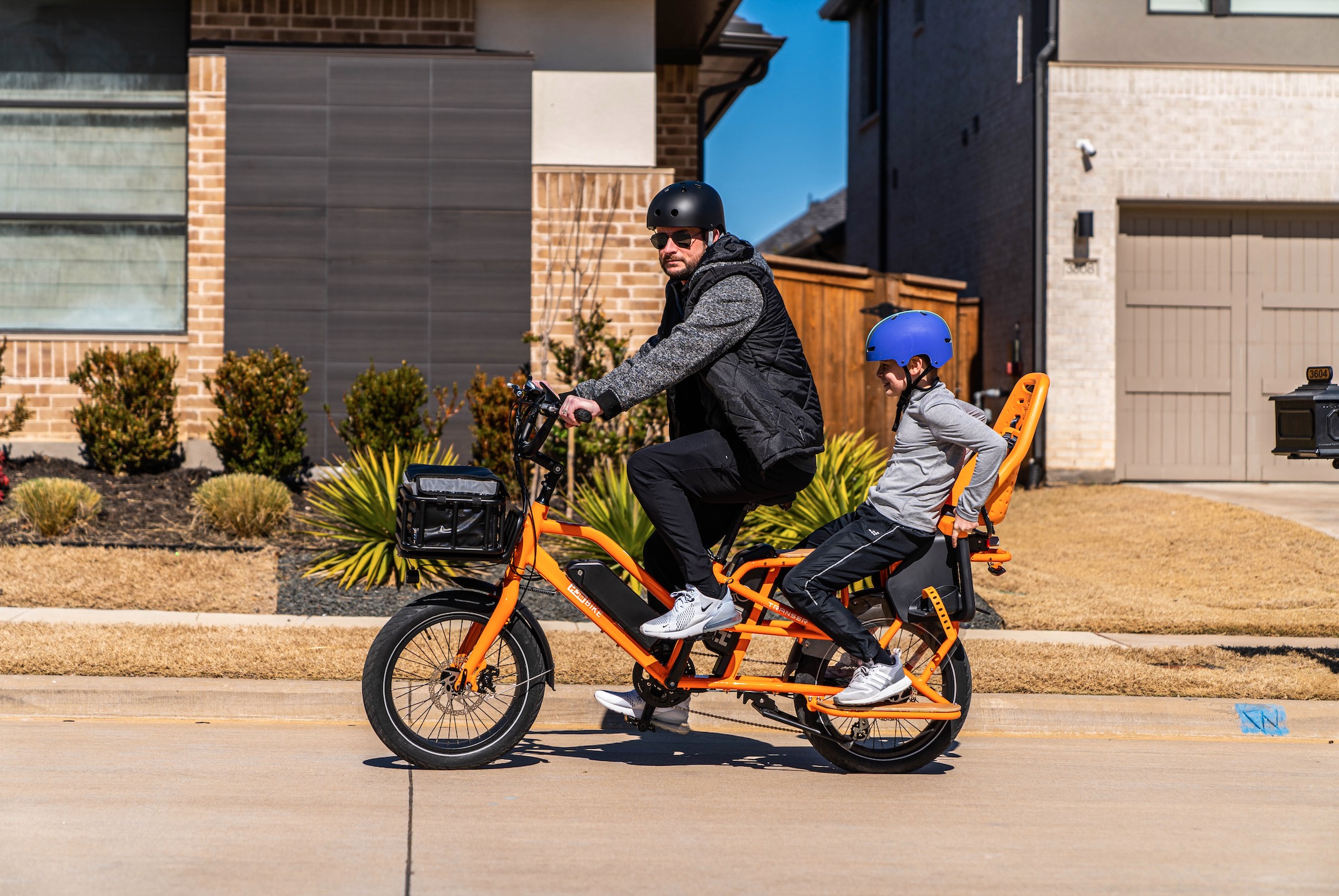 HJM Transer Cargo e-bike with rider and passenger.