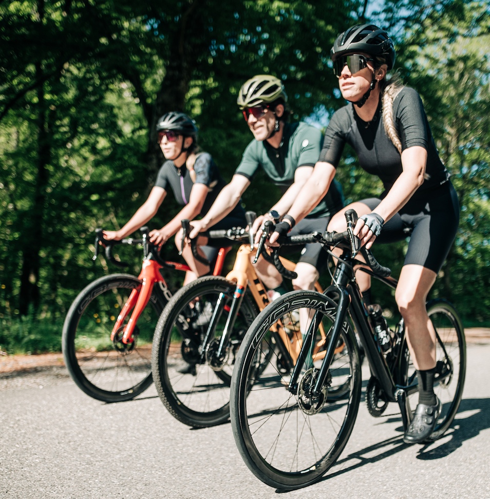 Three people riding bikes with Corima Essentia wheels.