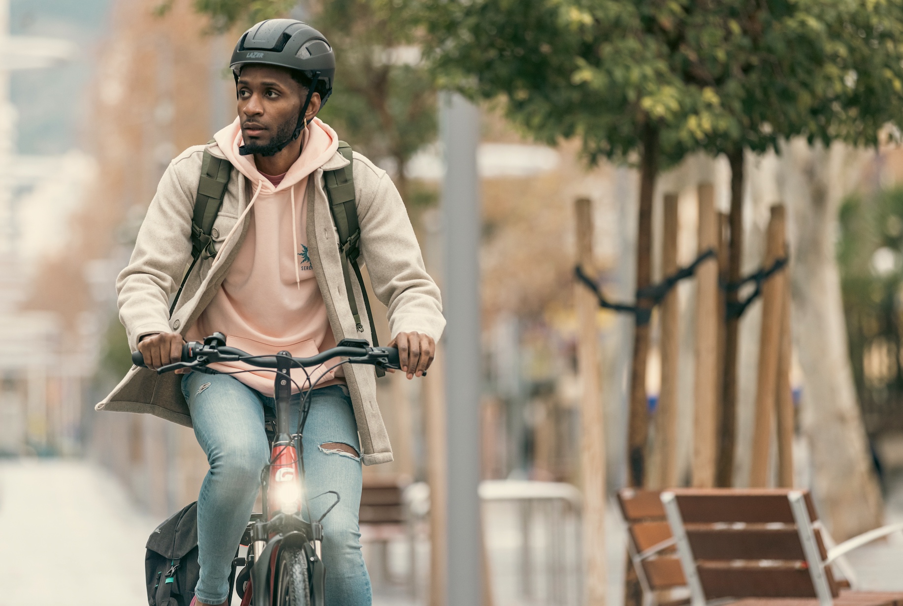 Man riding a bike wearing a Lazer Cityzen KinetiCore helmet.
