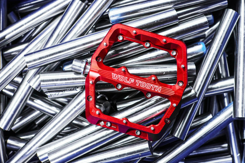 A red Wolf Tooth Component Aluminum Waveform Pedal
