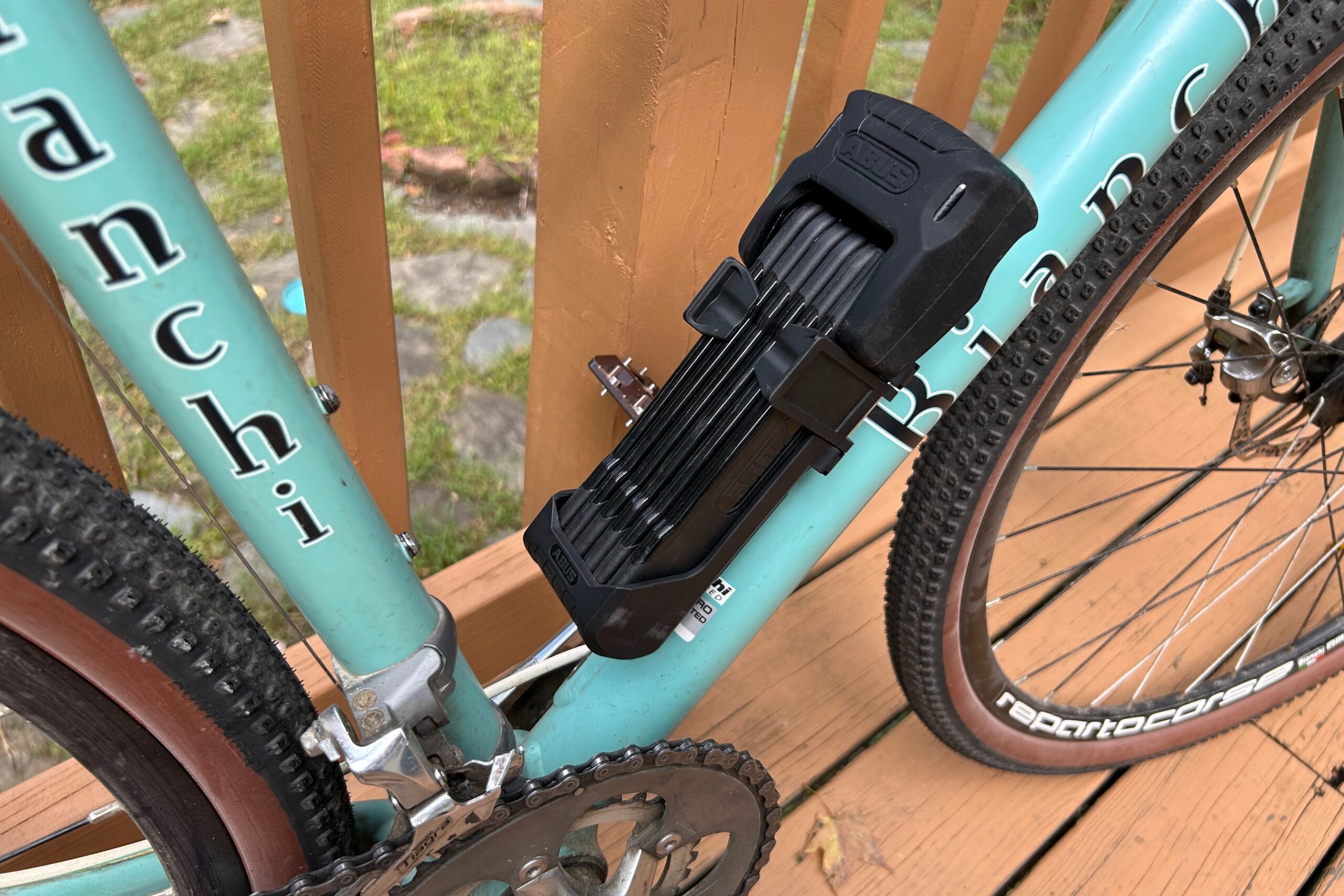 A folding bike lock mounted to a bike frame for transport