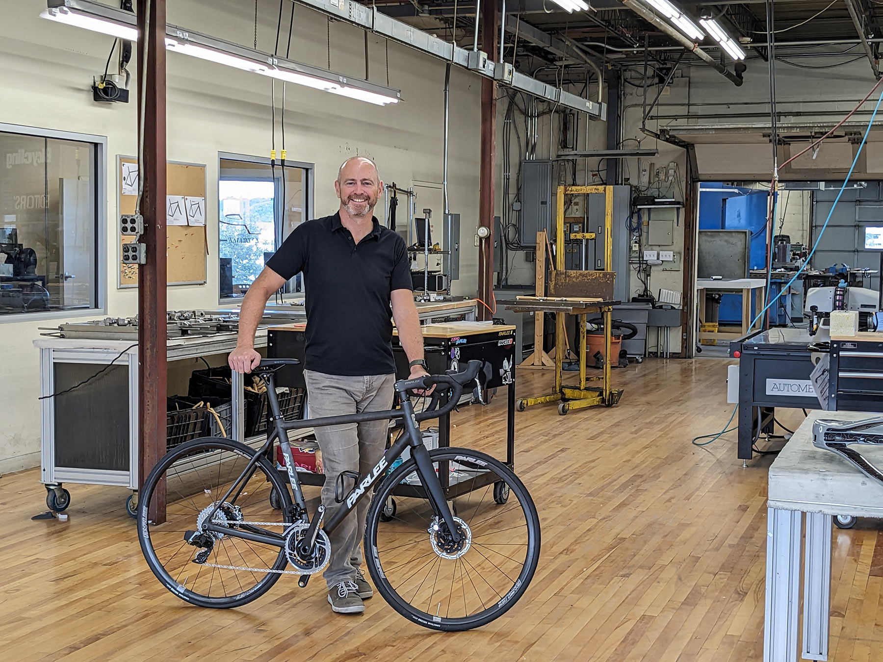 parlee cycles new owner John Harrison standing by a Z-series road bike