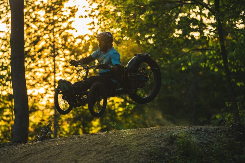 GREG DURSO riding an adaptive mountain bike on driving range trails in Vermont