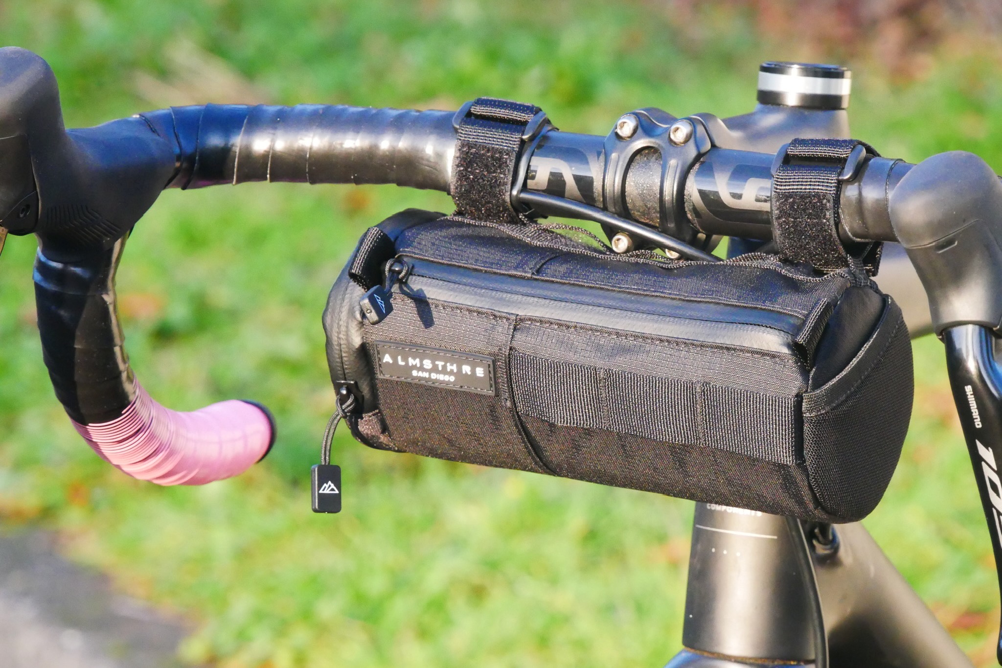 The ALMSTHRE Compact Bar bag mounted on a road bike handlebar