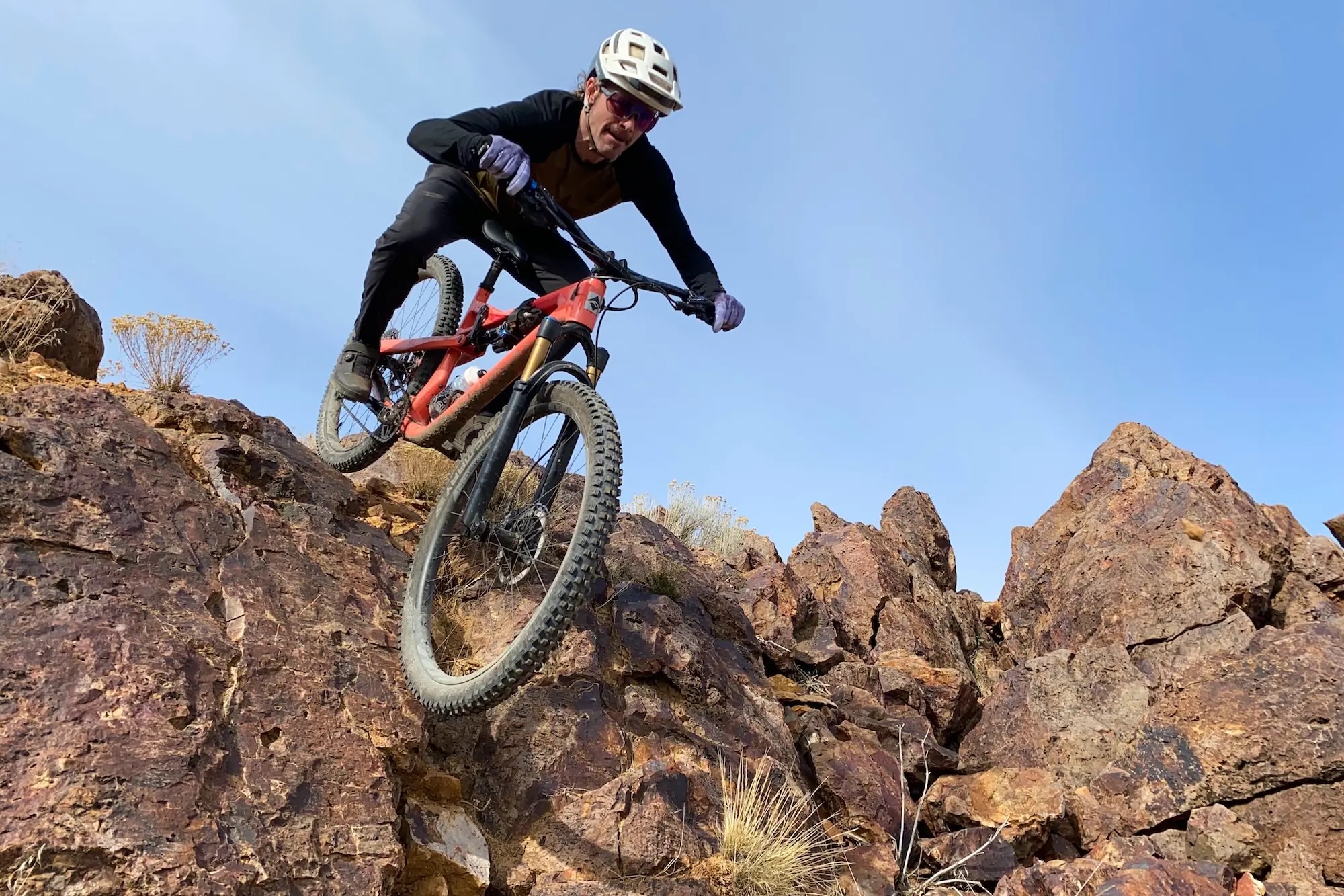 riding over a steep rock roll with the dropper post low