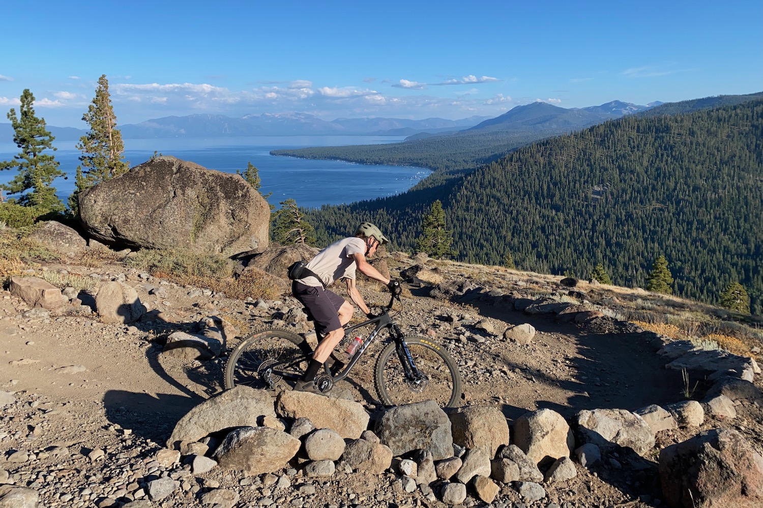 Jeremy testing a dropper post on a trail high above lake tahoe