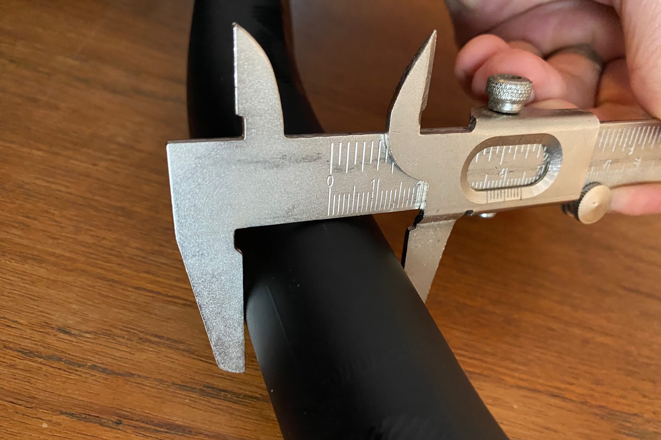Measuring the clamp diameter of a mountain bike handlebar with a caliper