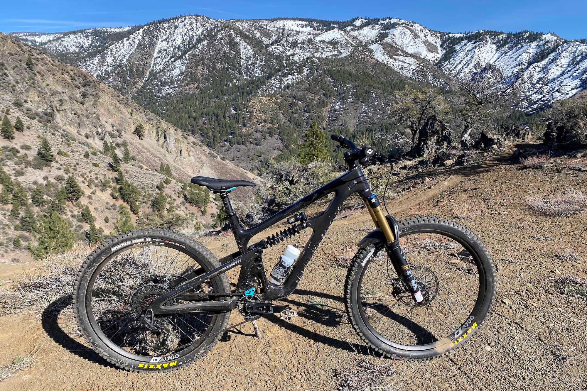 The Yeti SB165 test bike set up for a glamour shot with snow covered mountains in the background