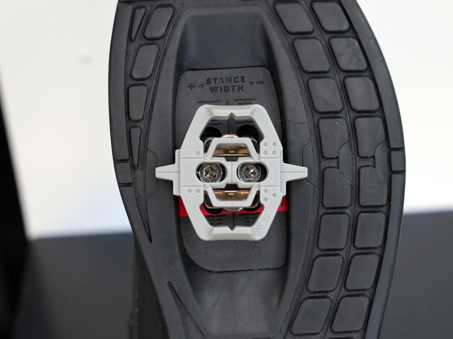 crank brothers cleat tool shown snapped onto a mountain bike shoe cleat
