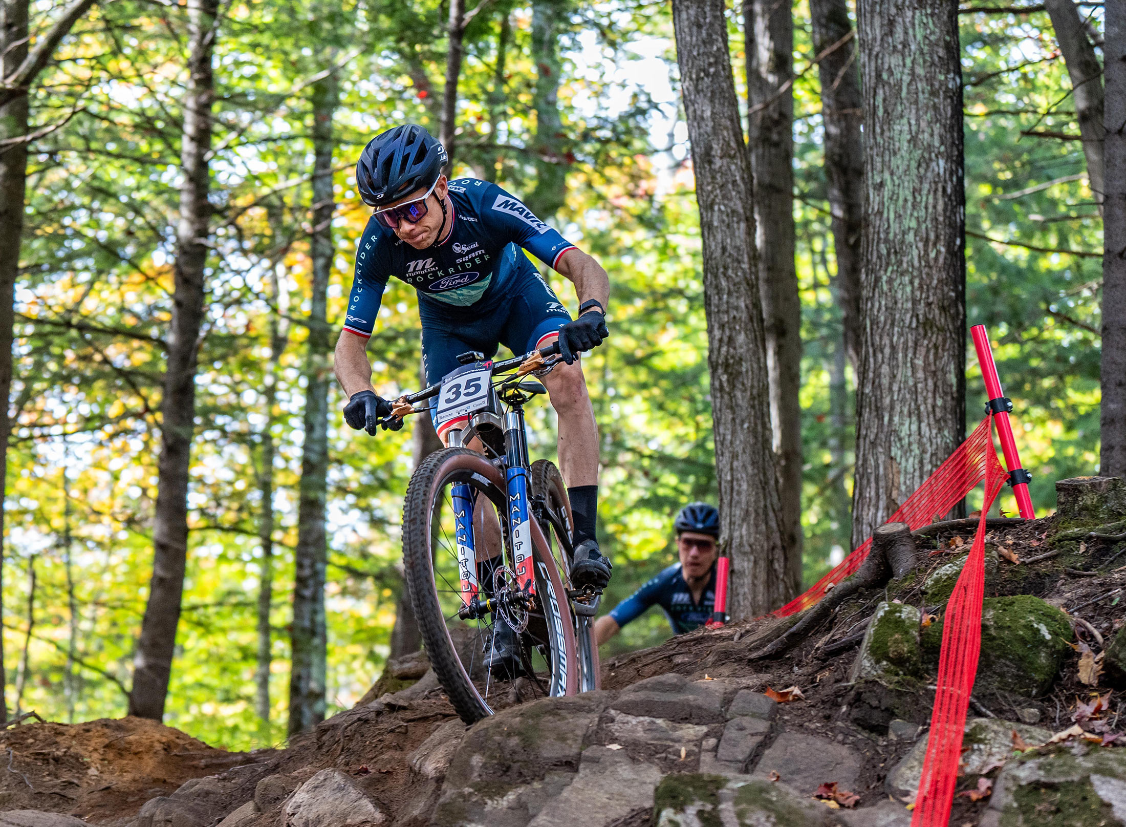 manitou xc suspension on a racers bike riding over roots.