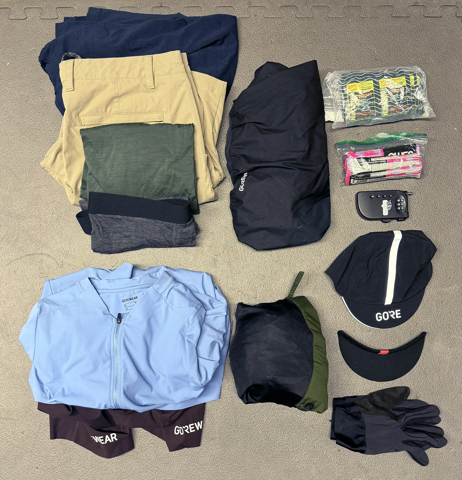 random bikepacking and cycling gear laid out for a trip.