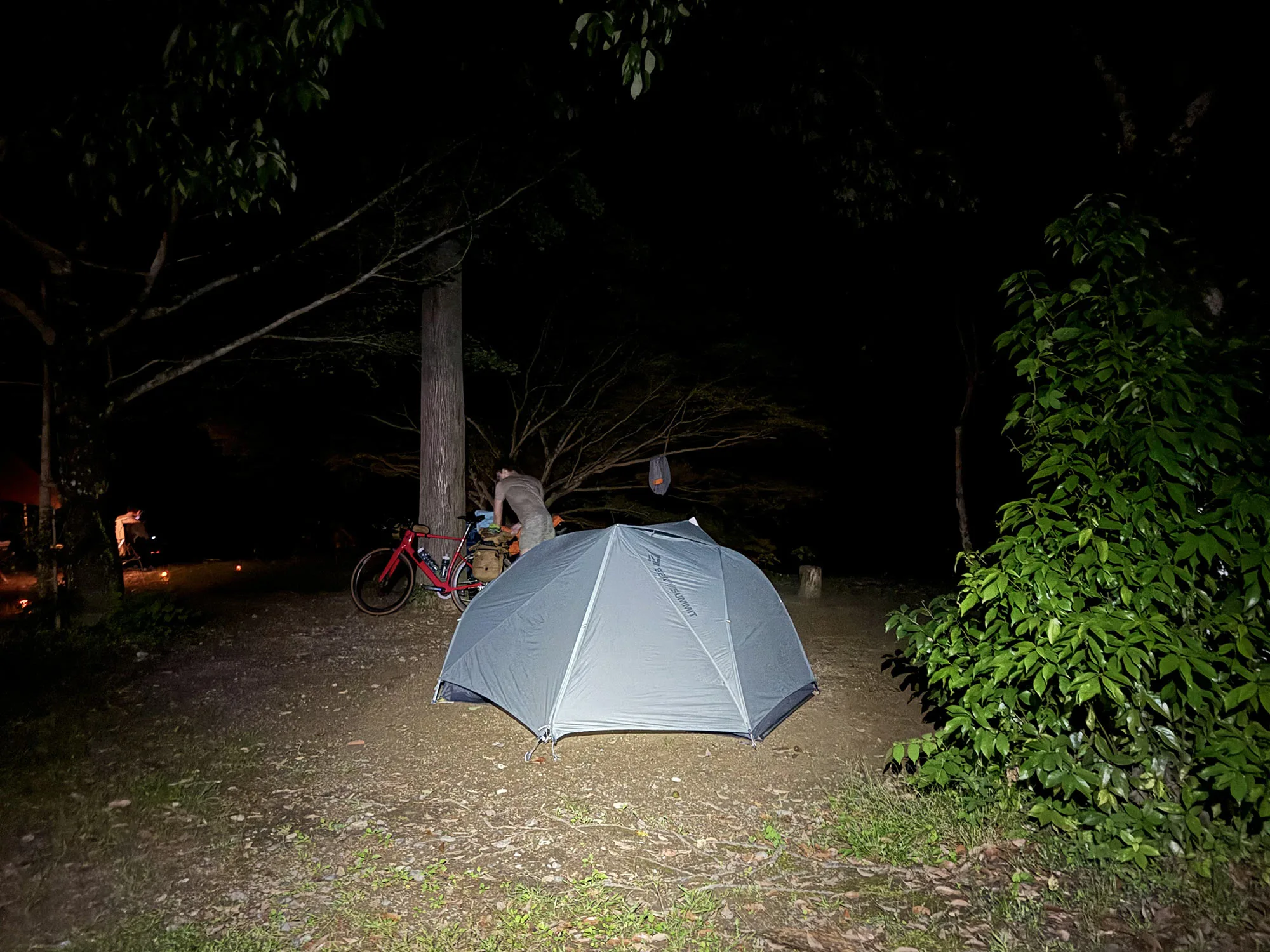 night photo of bikepacking tent and camp in kii peninsula, japan.
