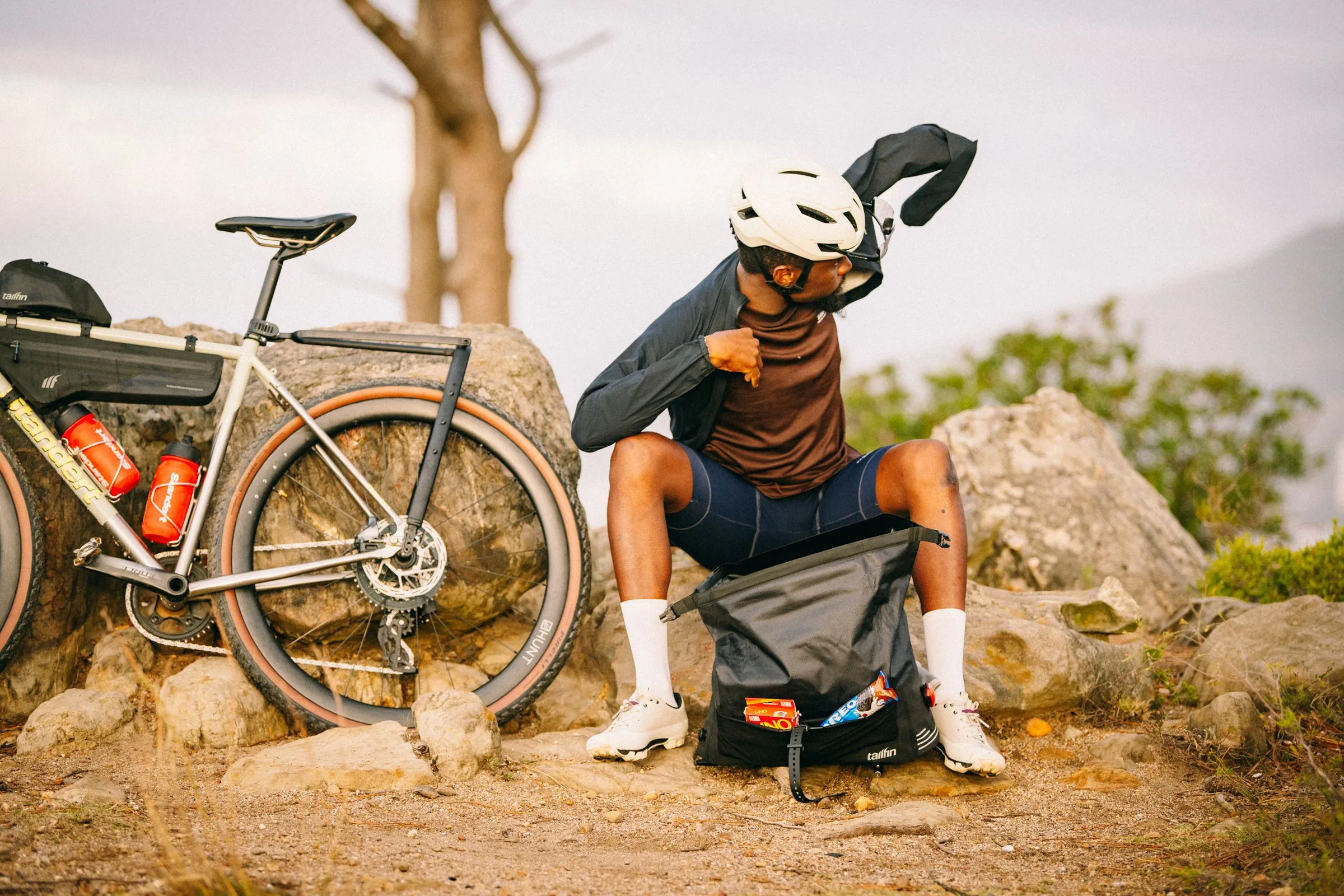 A bike packer sits with his AP18 pack removed from his bike