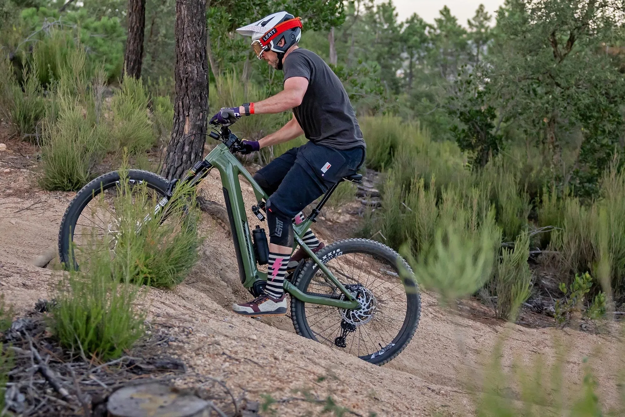 Cory riding up a steep trail on the Merida eOne-Eighty eBike with a Bosch CX motor.