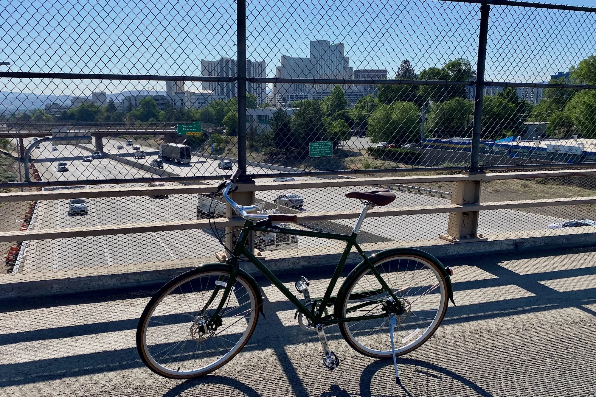 The Brooklyn Driggs 8I Disc parked on a bridge over the interstate with the downtown Reno in the background.