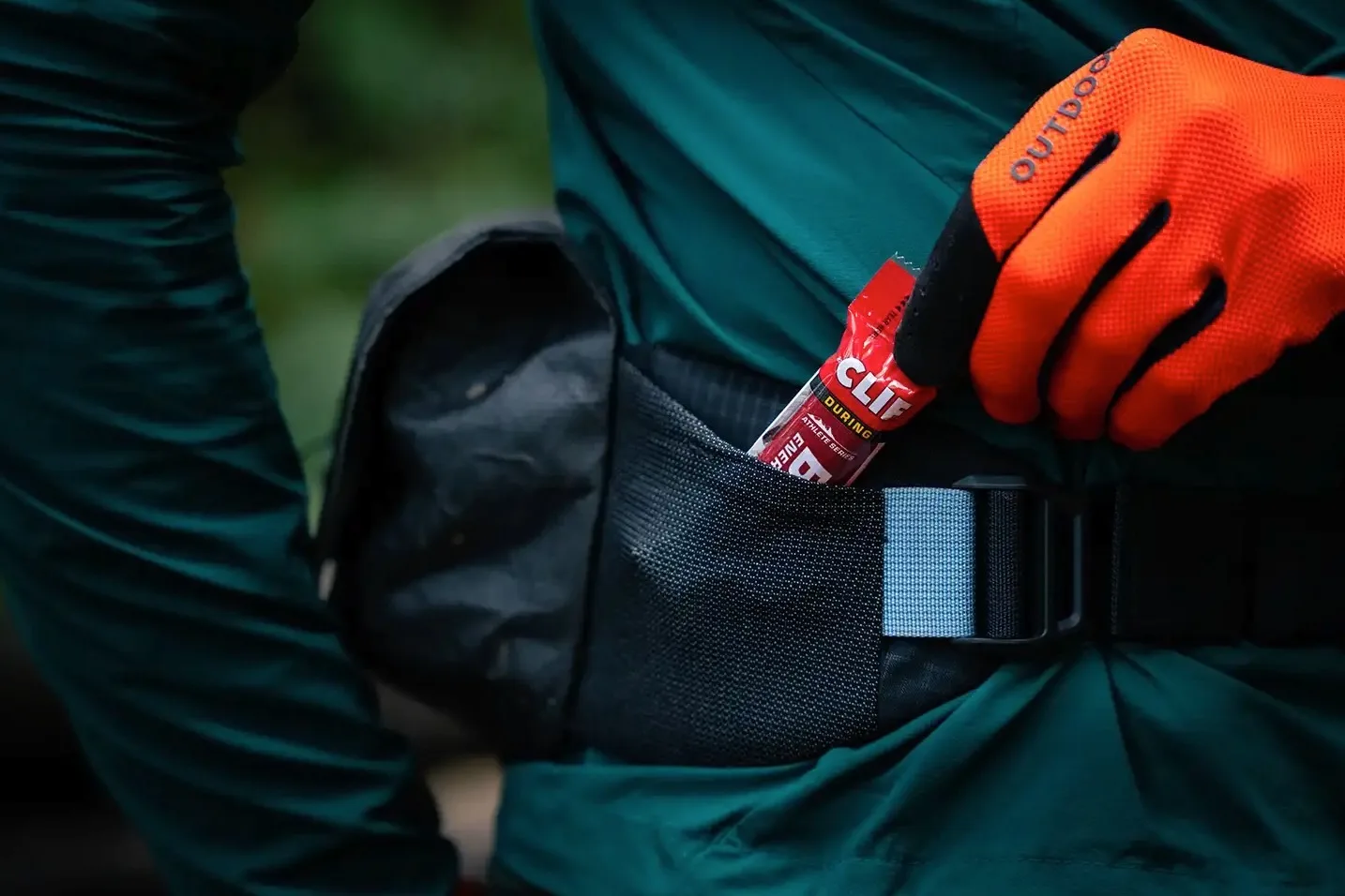 Pulling a snack out of the hip wing pockets on the Venture 3D hip pack