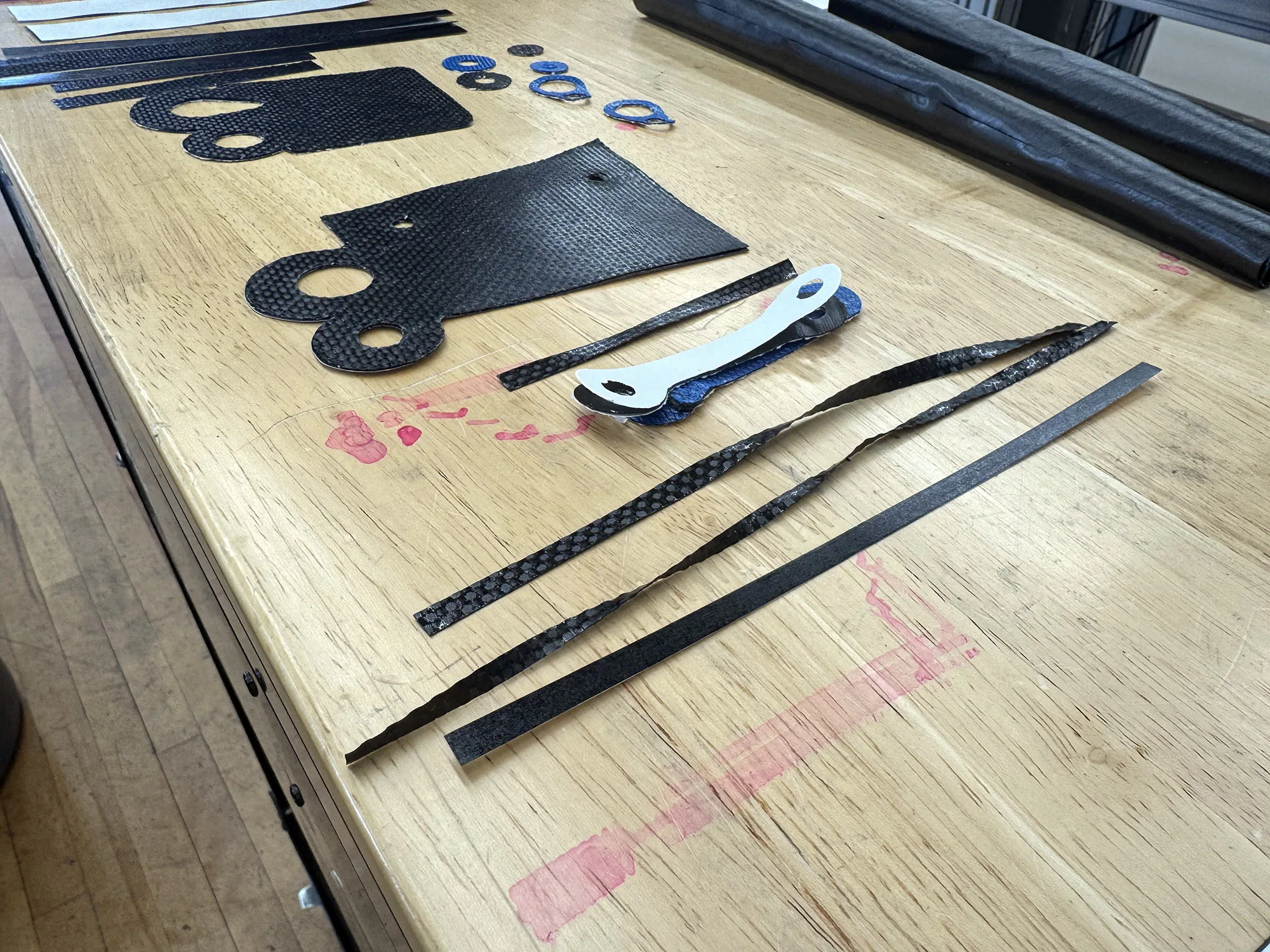 parlee factory work table with carbon fiber pieces used to make a road bike fork.