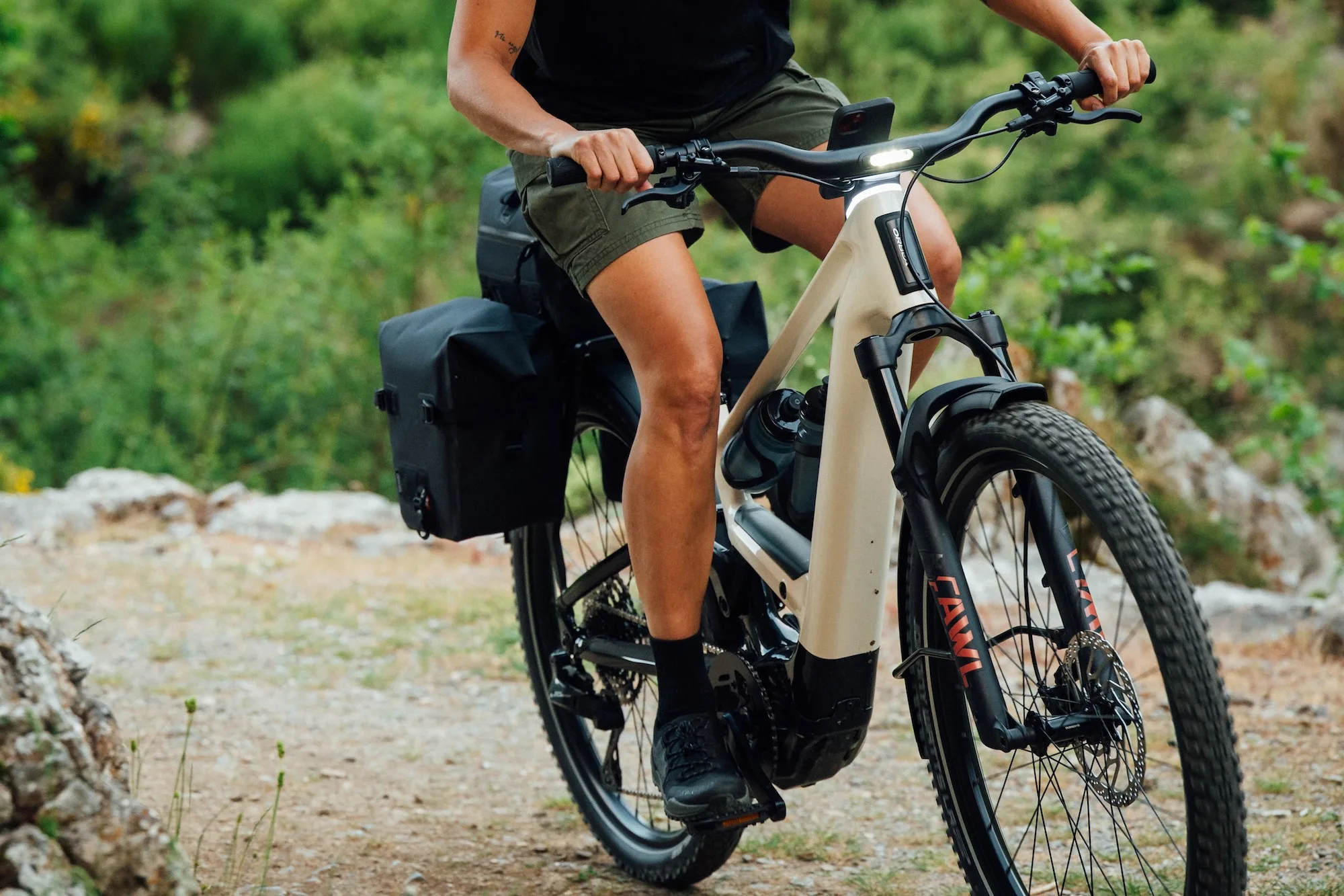 A rider on the Orbea Muga riding on a gravel road.