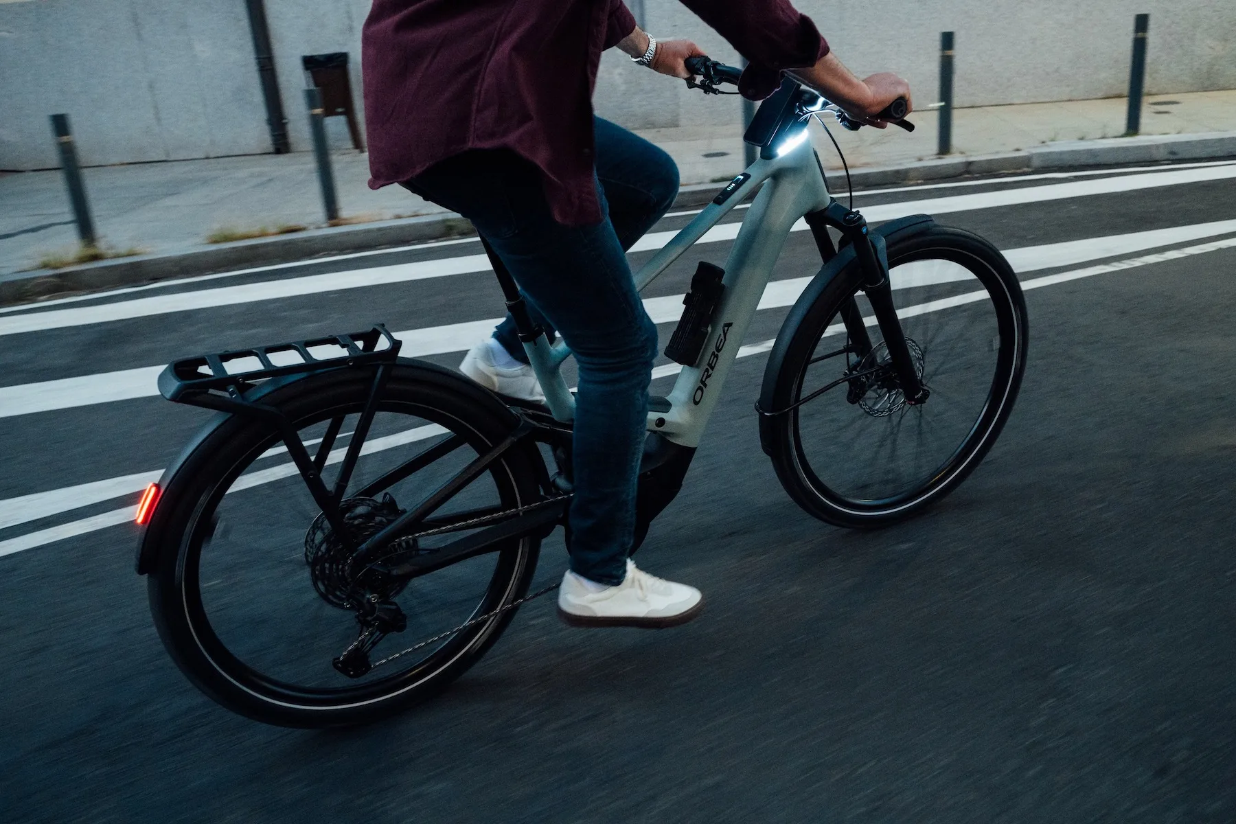 A rider on a city street while riding the Orbea Muga