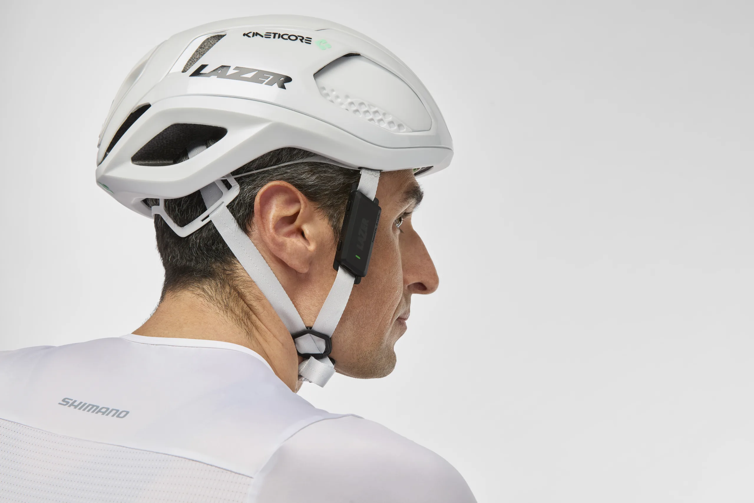 a side profile image of a rider with a Lazer VeloVox on his helmet strap