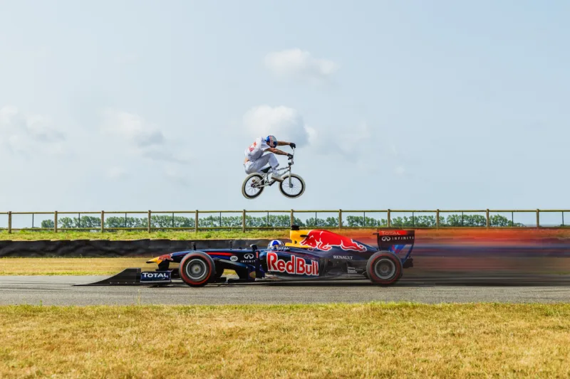 Kriss Kyle Jumps a BMX Bike Over a Moving F1 Car Driven by David Coulthard