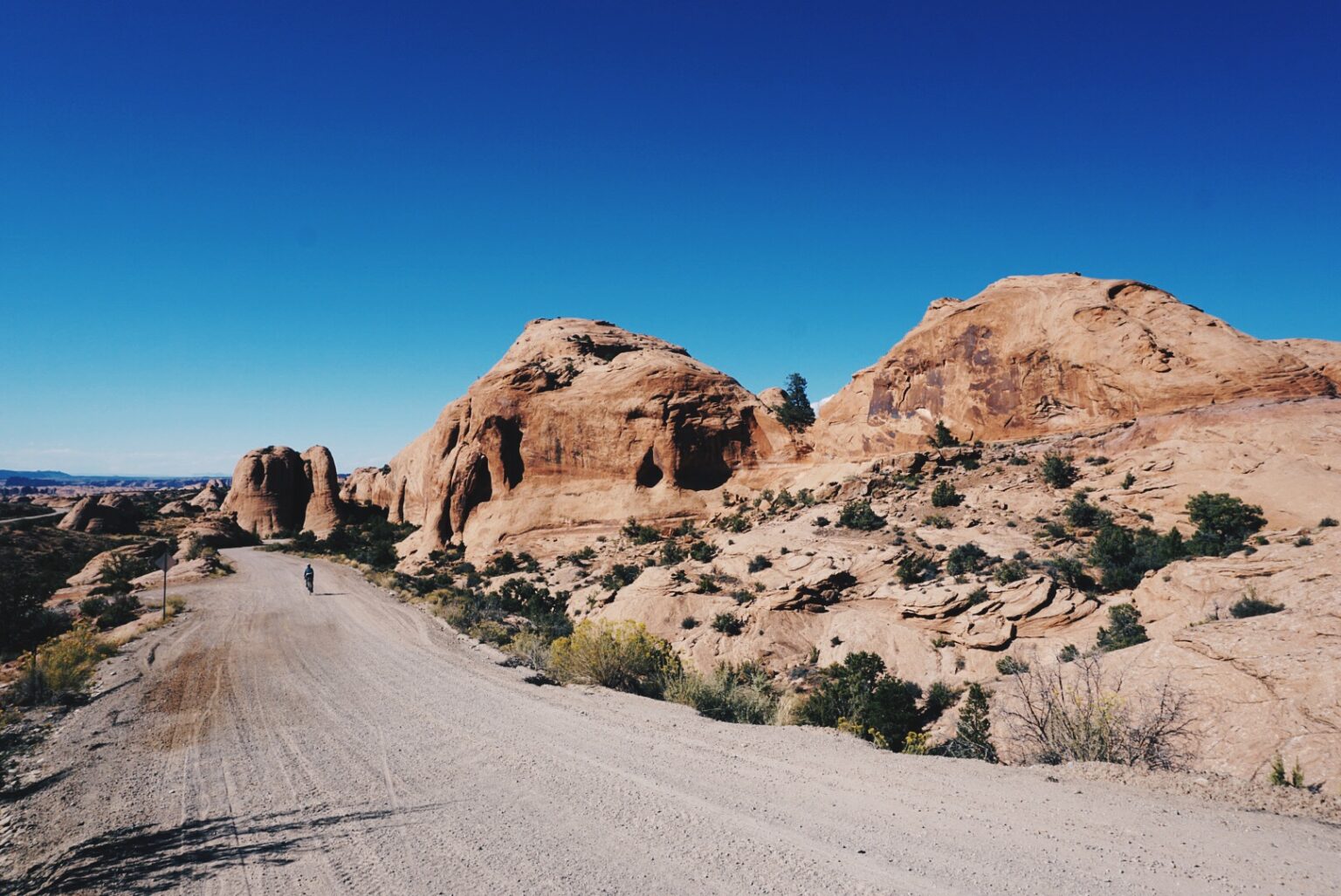 Swallow riding through a rocky desert landscape on the TAT