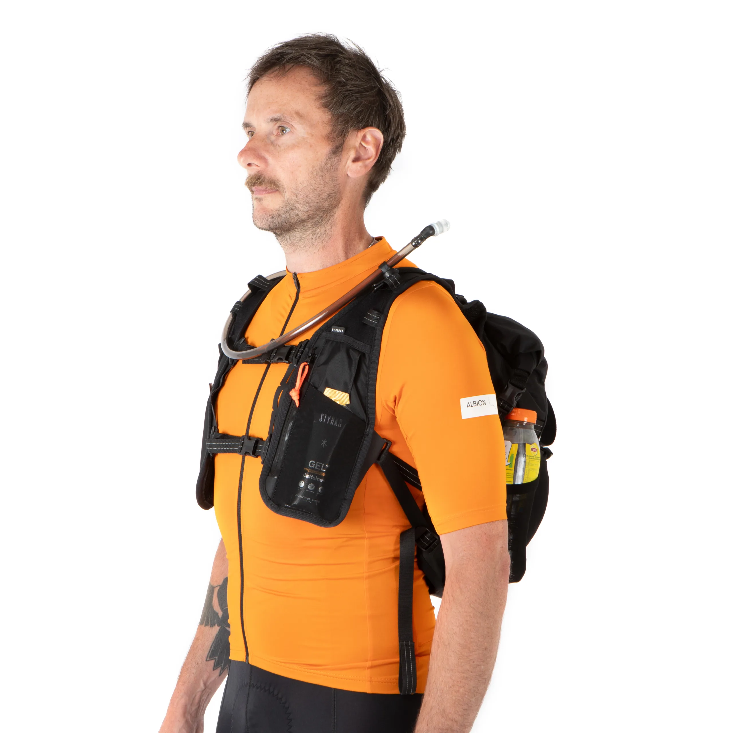A man in an orange jersey and a Restrap Rolltop Hydration Vest