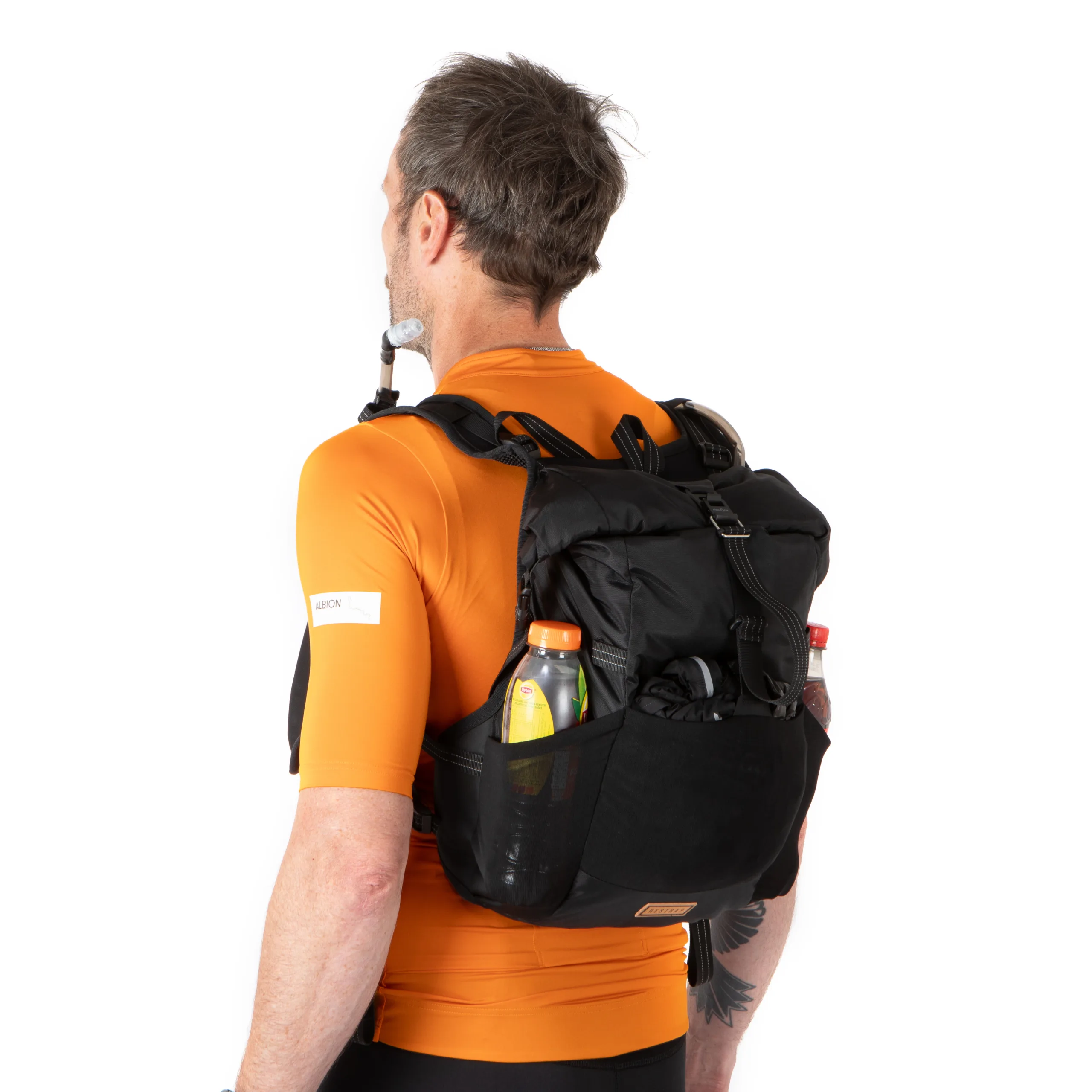 A man in an orange jersey wearing a Restrap Rolltop Hydration Vest left/rear profile