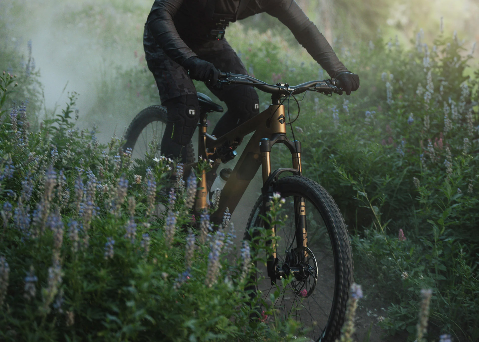 closeup of new ari nebo peak lightweight trail e-mountain bike riding through flowers.