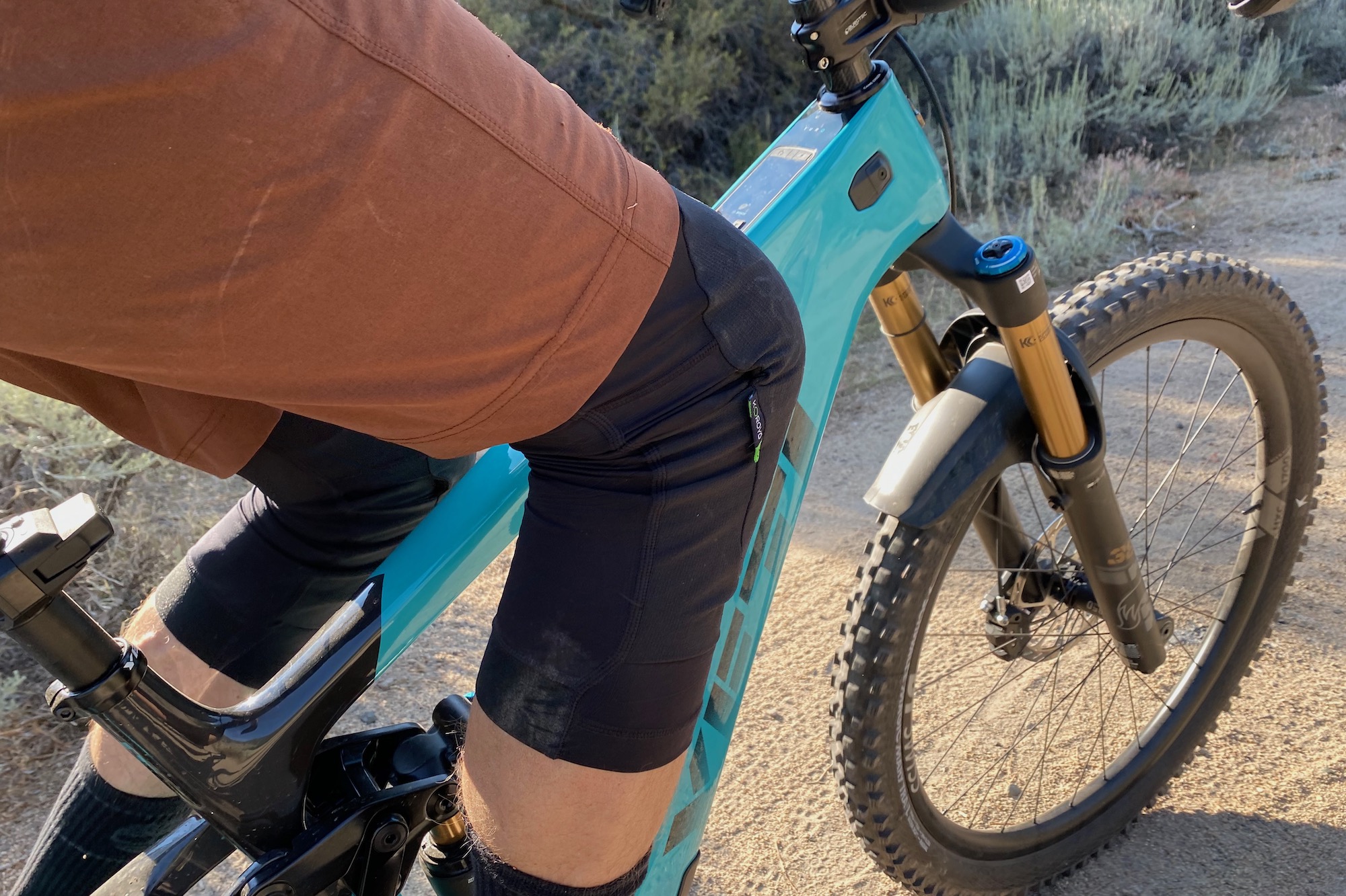 pedaling an eMTB while testing the Enduro Pro Kne Guards