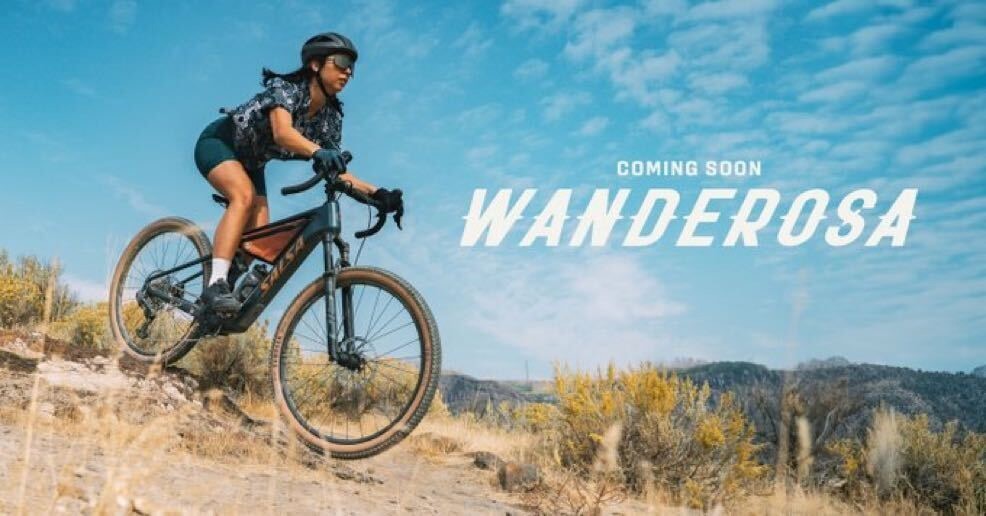a woman riding the new Salsa Wanderosa electric drop bar adventure bike
