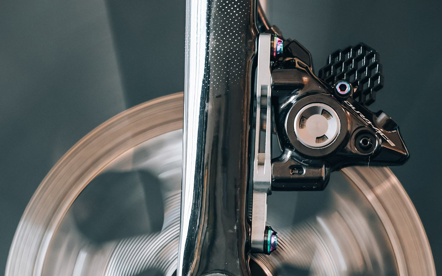 absoluteblack flat mount brake adapter and titanium bolts on a bicycle fork.
