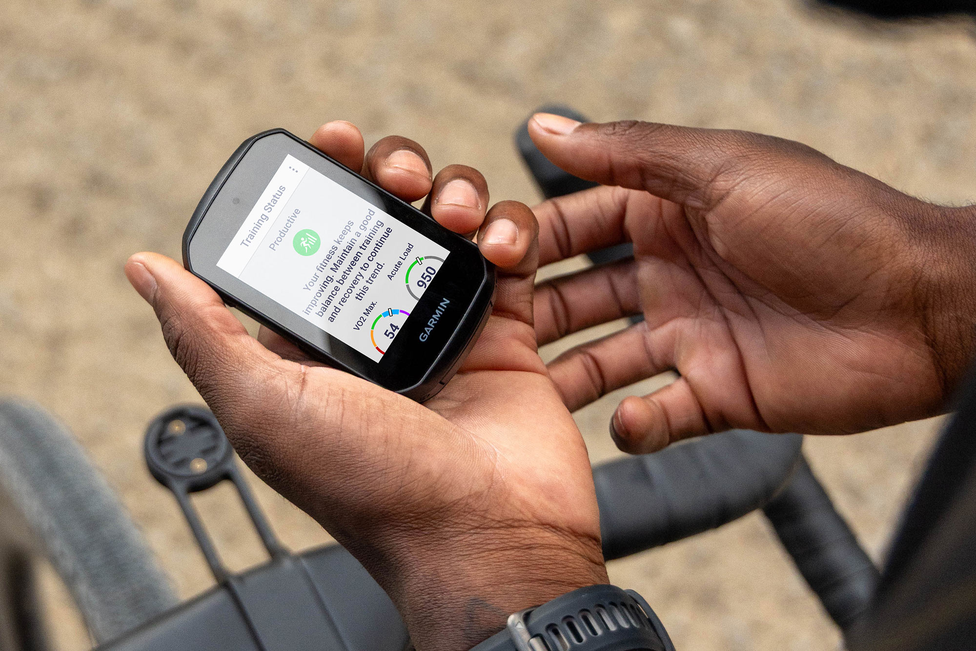 cyclist holding new garmin edge 550 850 GPS cycling computer.