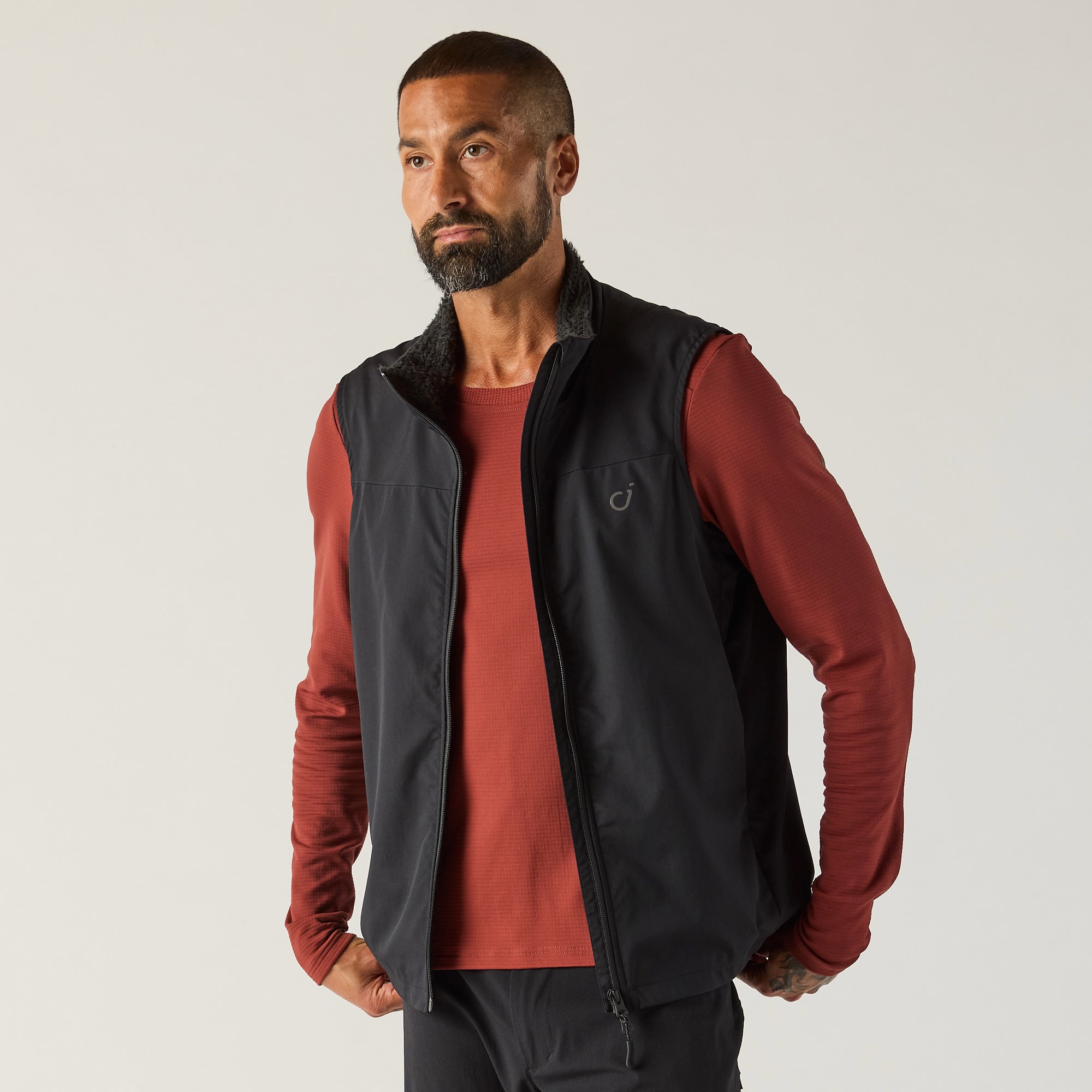studio image of a man wearing the trail alpha insulated vest