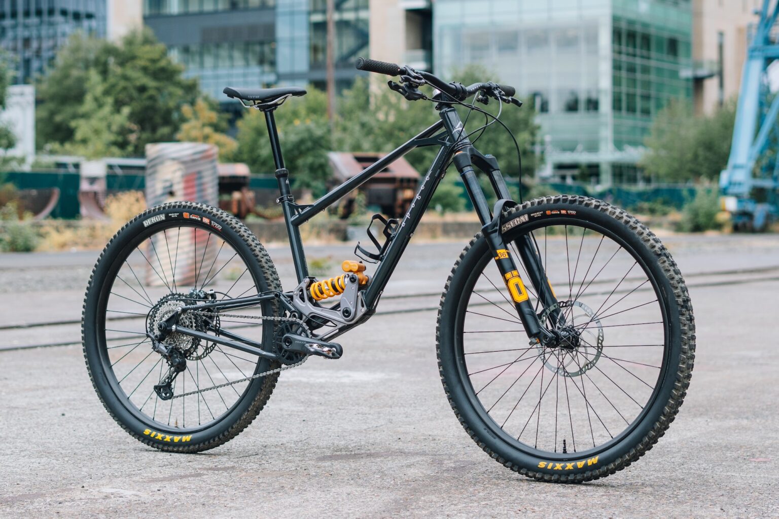 A dark blue Apogee One with a custom build and Ohlins suspension