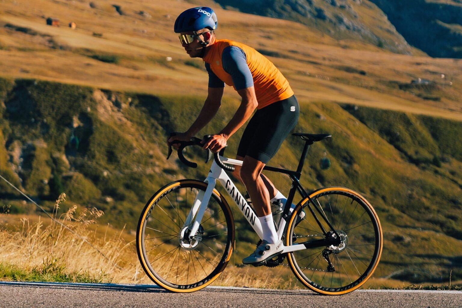 stock image of a road biker riding with reynolds road bike wheels.