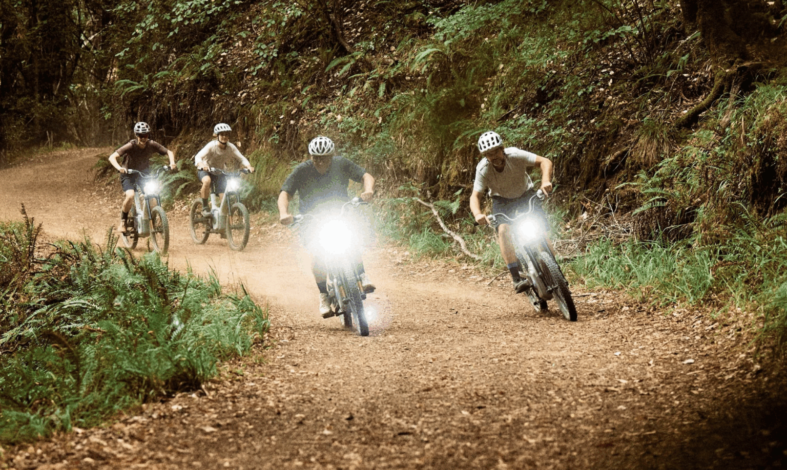 Rivian Also TM-B being ridden by people on a dirt road