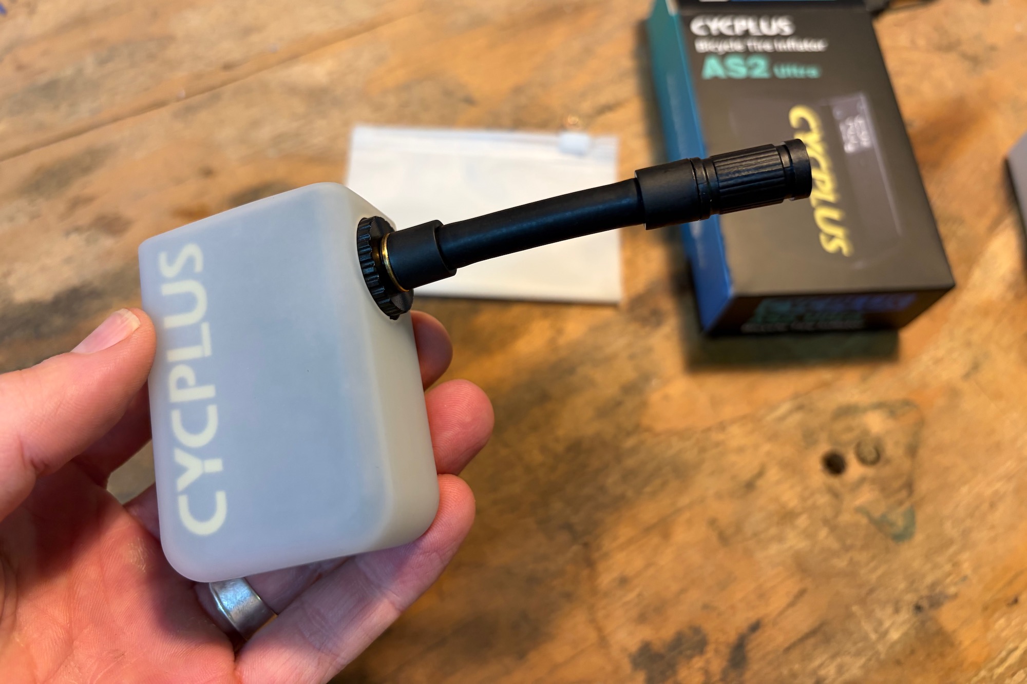 holding the Cycplus AS2 Ultra with the hose attached.