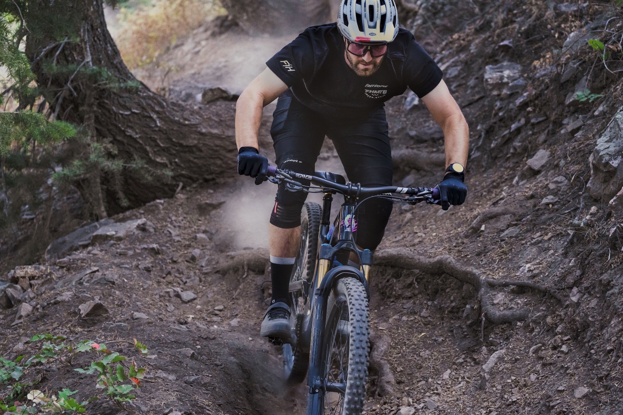 a mountain biker riding a rocky trail using the ENVE Fractal grips.